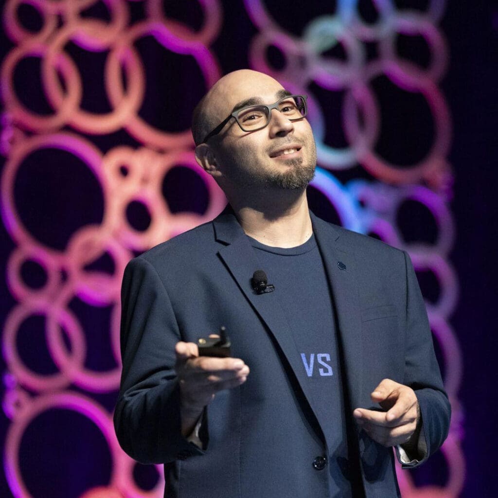 Bald man in blazer presenting at ApartmentSEO® conference in Long Beach, CA.